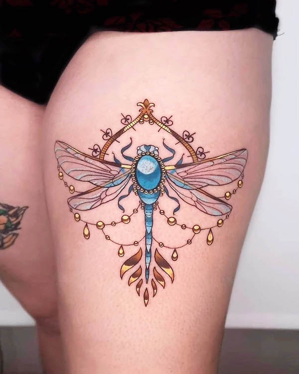 Antique dragonfly thigh tattoo by @charlie_claudel