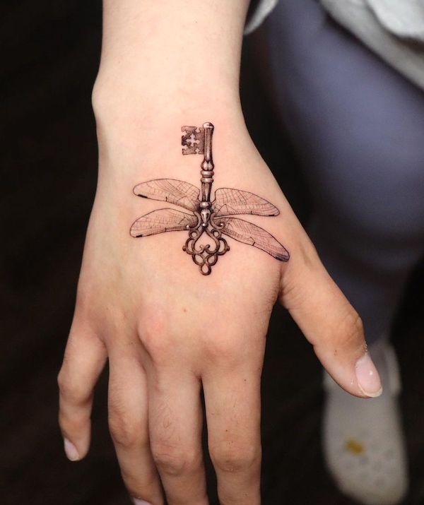 Dragonfly and key hand tattoo by @reyr1tattoo